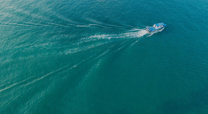 Boat sailing across blue water