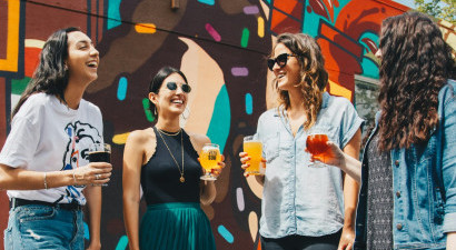 People_laughing_stood_around_with_drinks.jpg