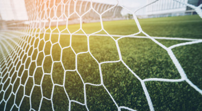 Goal net with view of football pitch