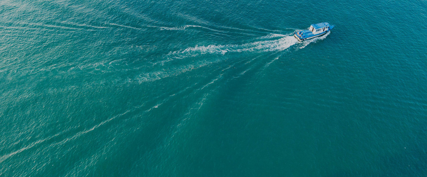 Boat sailing across blue water