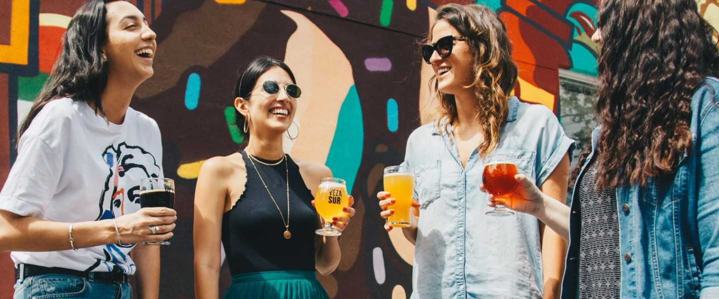 People_laughing_stood_around_with_drinks.jpg