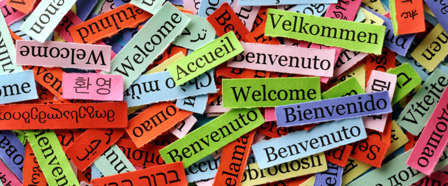 Welcome_written_on_strips_of_paper_in_many_languages_.jpg