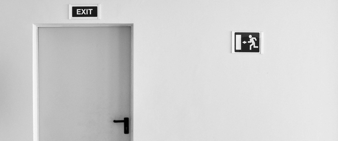 Emergency Exit on White Wall