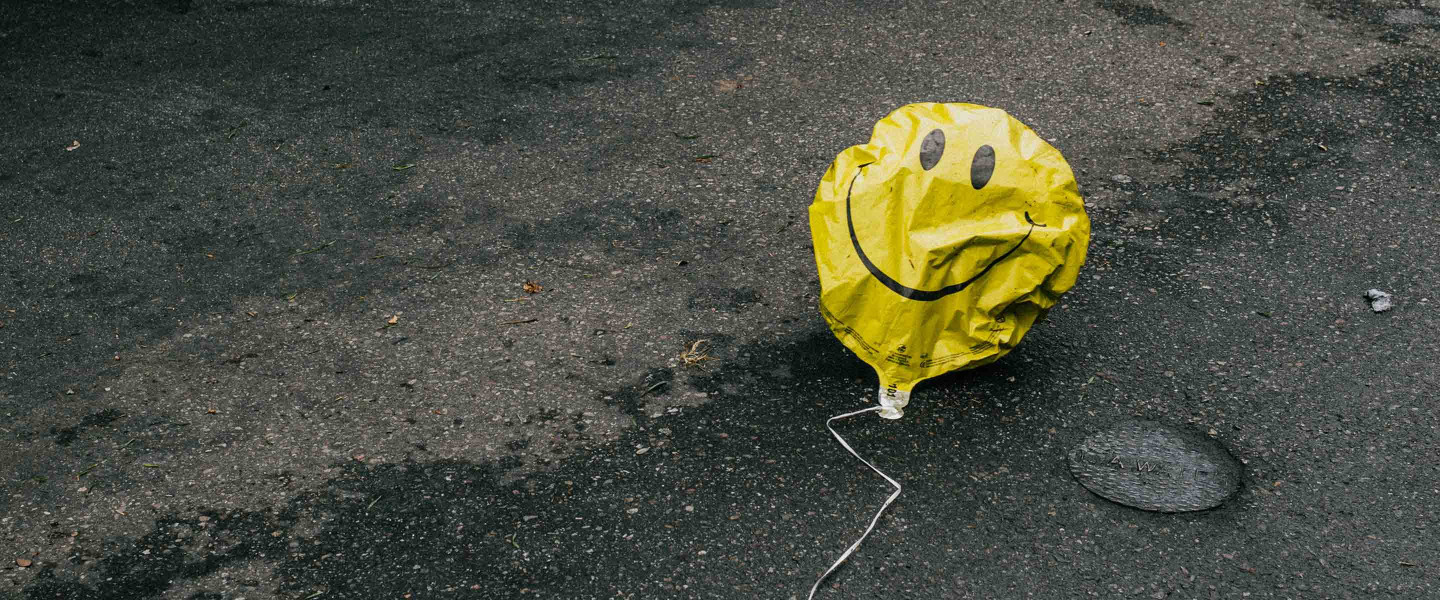 Smiley face balloon on the floor