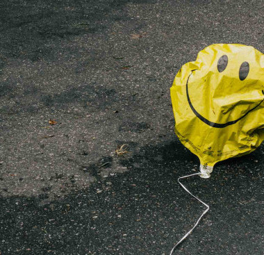 Smiley face balloon on the floor